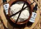 Two bottles of vanilla bean beard oil next to a bowl of vanilla ice cream on a wooden surface